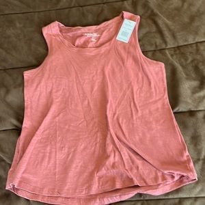 Rosé colored tank with rolled neckline.